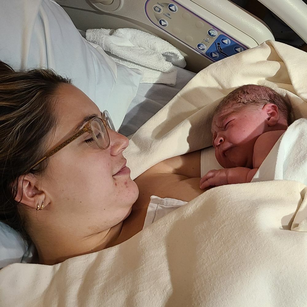 woman holding baby after birth